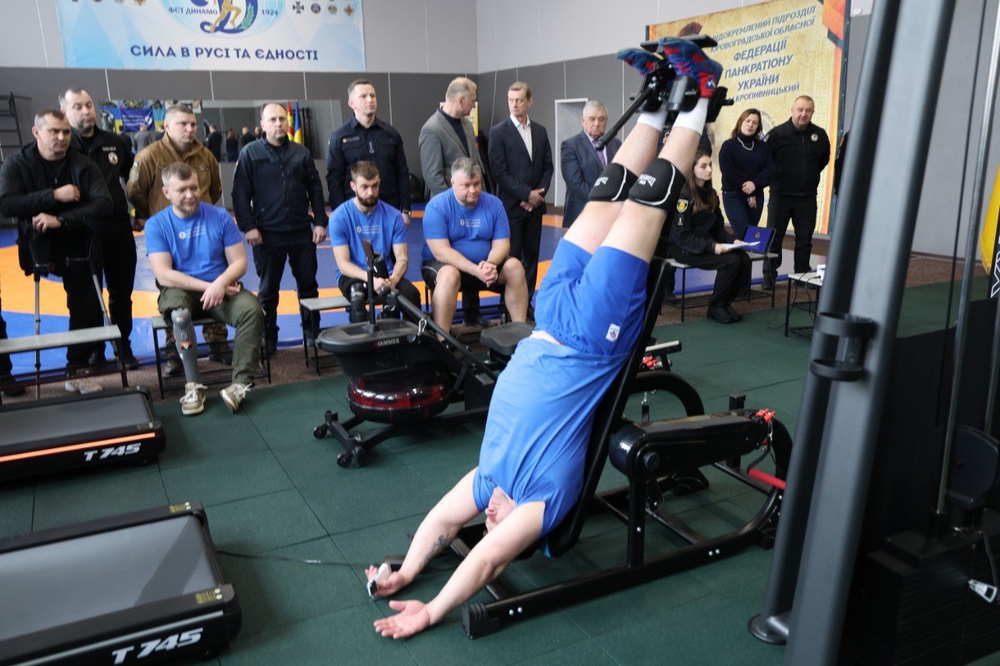 Чоловік виконує вправу на спортивному тренажері